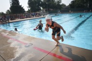 Evelyn DeGeest finishes her lap and runs to the bikes during the Parks and Recreation Youth Triathlon at Kuehn Park Friday, Aug 10, in Sioux Falls.