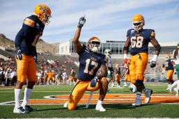 UTEP's Justin Garrett scores a touchdown during the game against Charlotte Saturday, Nov. 9, at the Sun Bowl in El Paso. Garrett had a message under his eyes that reads "RIP sister."